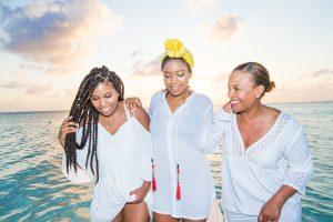 Three African American women on a beach shore - hair style for any weather