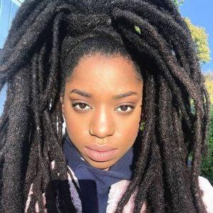 African American woman with long, freeform locs - your guide to maintaining and styling locs