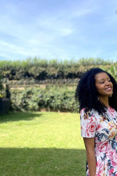 Black woman with curly hair smiling