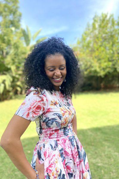 Black woman with curly hair smiling