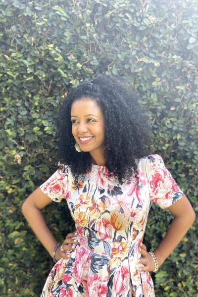 Black woman with curly hair smiling